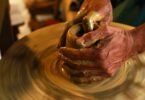 potter shaping a clay pot to represent the system molding a cop
