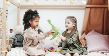 two children playing with toys friendship