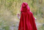 girl in red cape in the forest