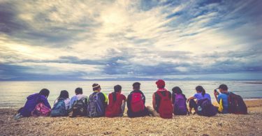 friends sand beach backpacks